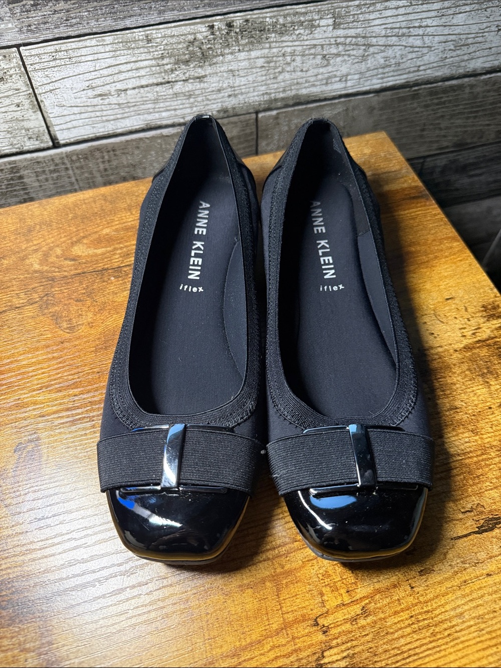 Anne Klein Black Slip-On Ballet Flats with Patent Cap and Bow Accent